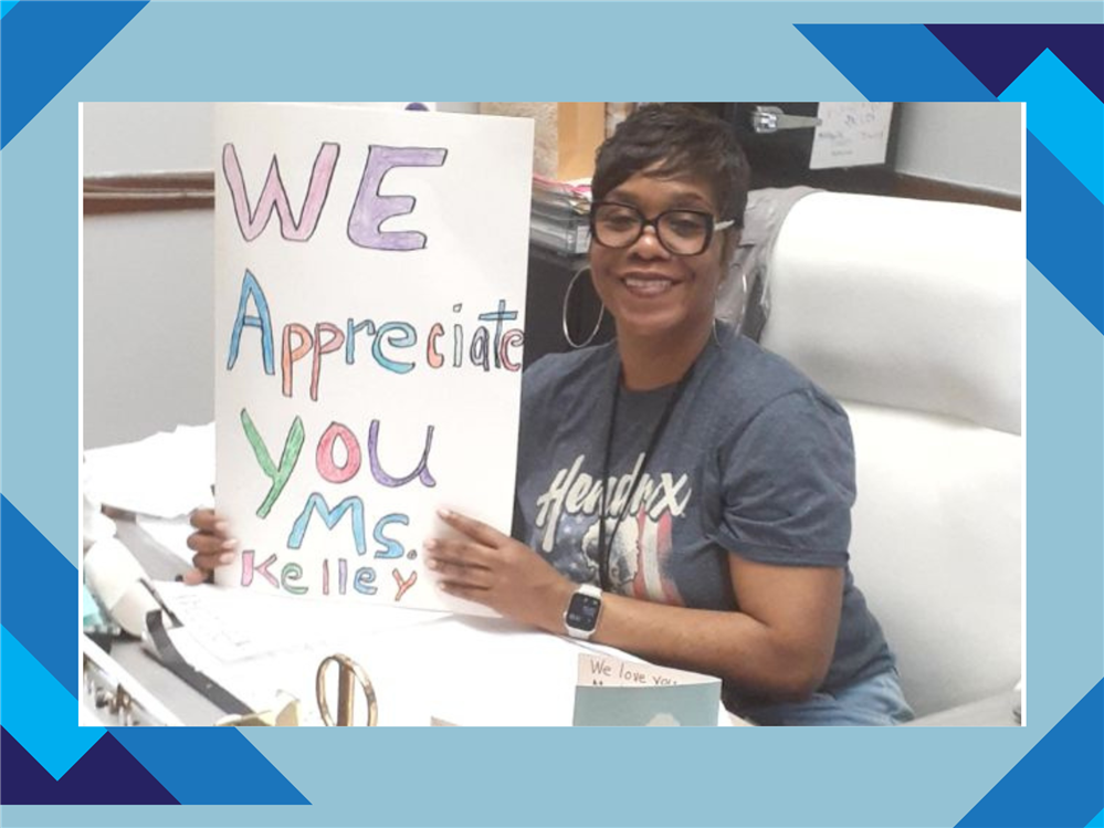  Assistant Principal holding a card
